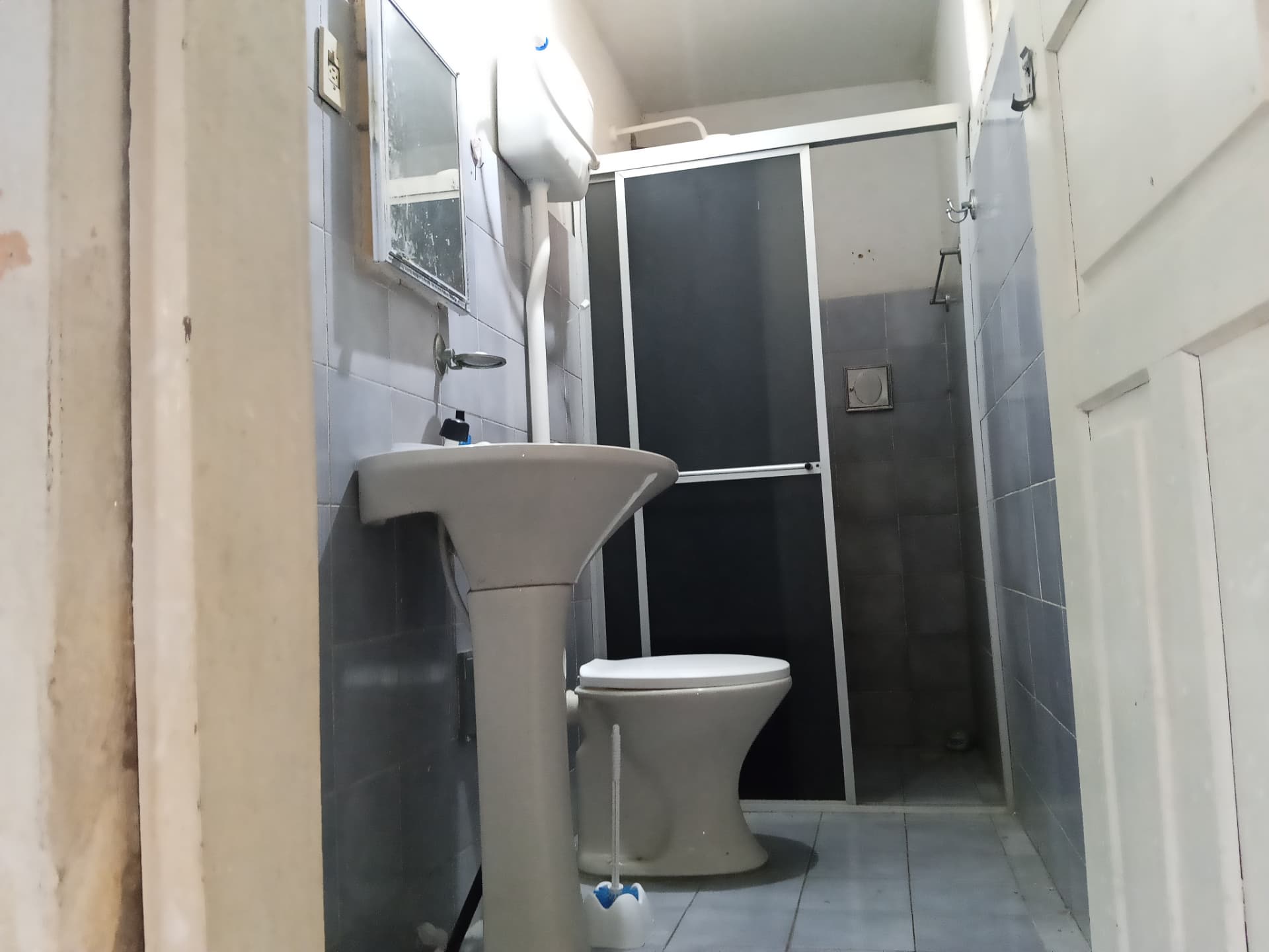 Banheiro privativo com pia e chuveiro